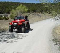 Off road vehicle traveling on dirt road